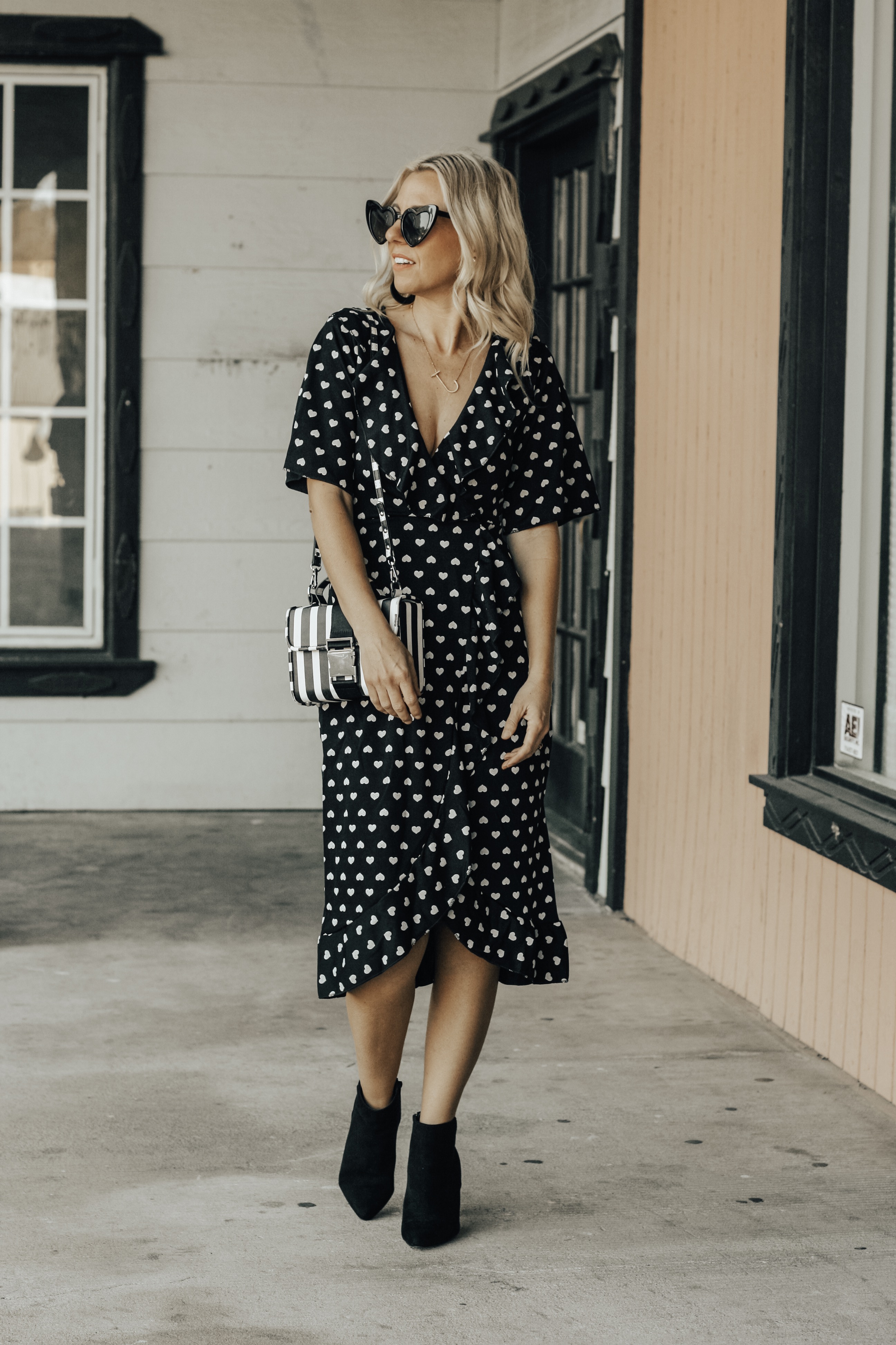 TWO VALENTINE'S DATE NIGHT LOOKS- Jaclyn De Leon Style + heard midi dress + black and white outfit + Valentine outfit inspo + asos + black booties + heart sunglasses + striped handbag + ruffle dot baby doll dress + abercrombie + faux fur jacket + stilettos + girls night out + dress up + spring street style