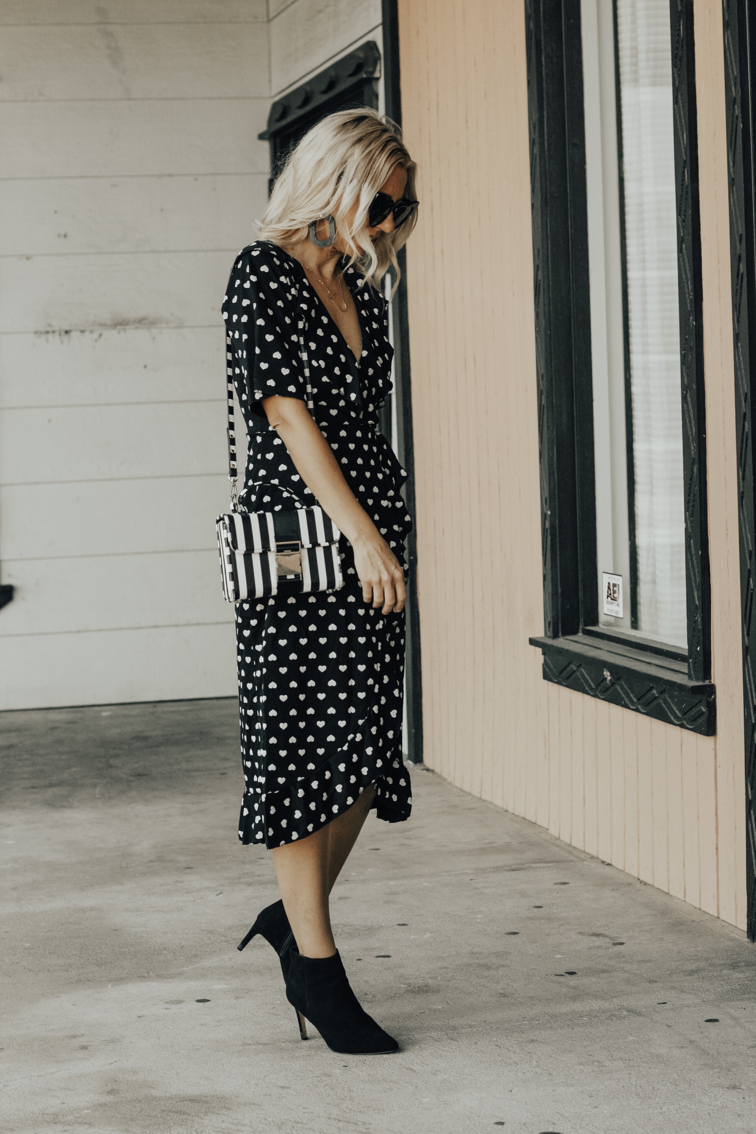 TWO VALENTINE'S DATE NIGHT LOOKS- Jaclyn De Leon Style + heard midi dress + black and white outfit + Valentine outfit inspo + asos + black booties + heart sunglasses + striped handbag + ruffle dot baby doll dress + abercrombie + faux fur jacket + stilettos + girls night out + dress up + spring street style