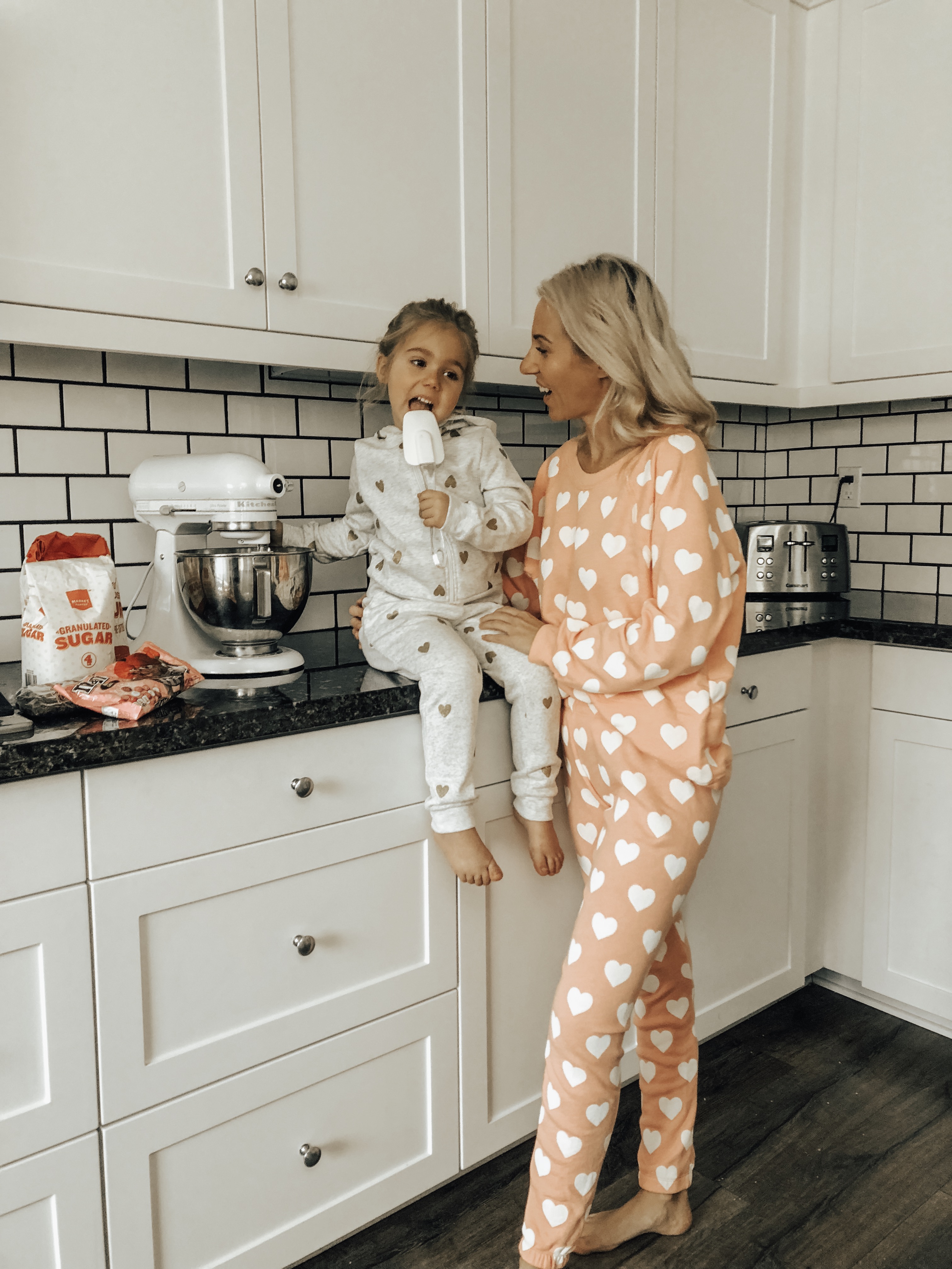 COZY & CASUAL VALENTINES AT HOME- Jaclyn De Leon Style + mommy and me making cookies + valentines inspired outfits + heart matching sets + pink + mini me + mom style + matching pajamas + at home making cookies + in the kitchen + matching outfits + mom life + kid style + nordstrom rack + h&m style