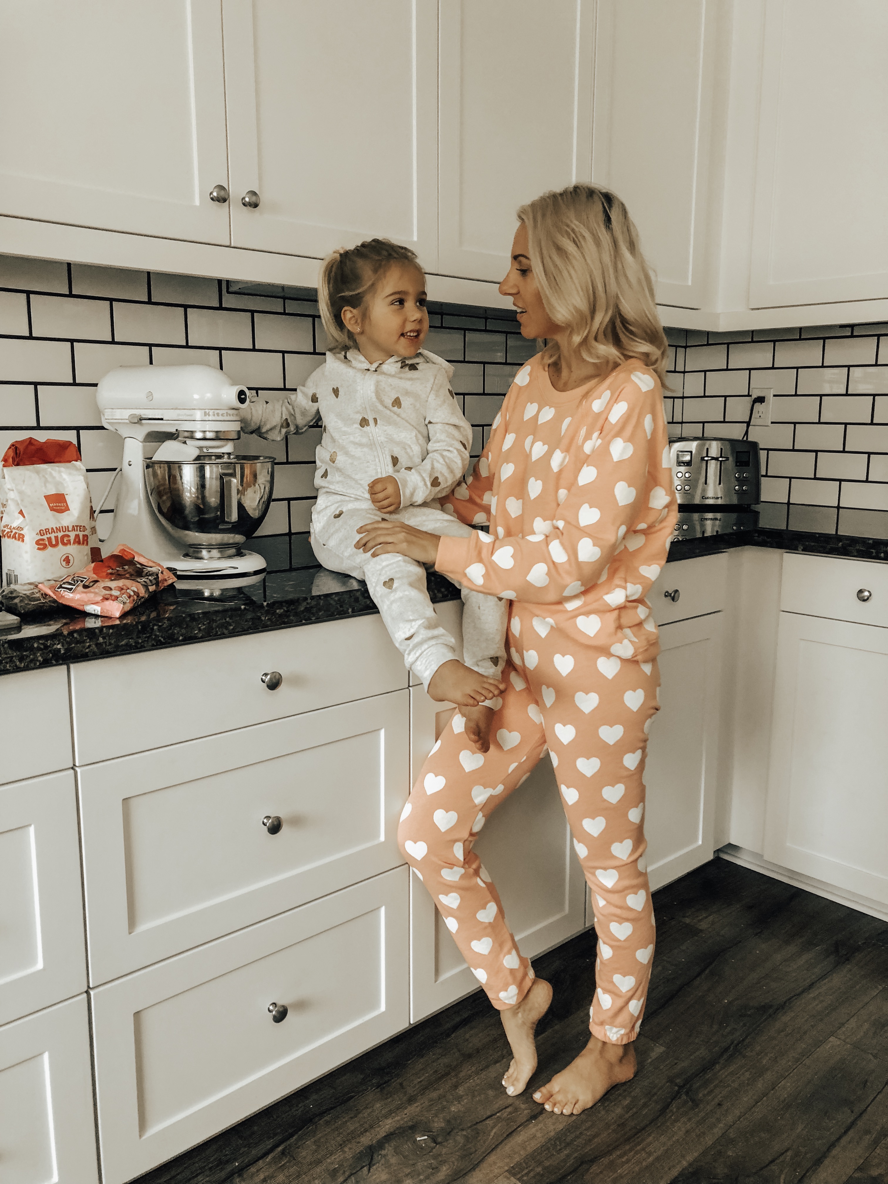 COZY & CASUAL VALENTINES AT HOME- Jaclyn De Leon Style + mommy and me making cookies + valentines inspired outfits + heart matching sets + pink + mini me + mom style + matching pajamas + at home making cookies + in the kitchen + matching outfits + mom life + kid style + nordstrom rack + h&m style